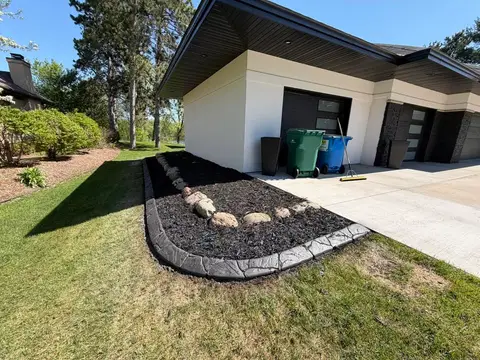 Concrete edging around landscaped area with rocks in Princeton, MN