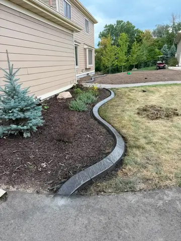 Curved concrete border alongside garden bed in Princeton, MN