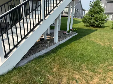 Rock-filled border along house foundation in Princeton, MN