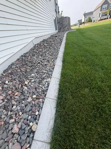 Concrete border around shrubs and grass in Princeton, MN