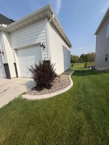 Concrete edging along foundation with rocks in Princeton, MN