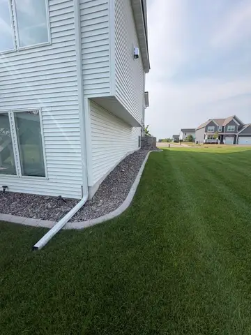 Concrete border with rocks along house in Princeton, MN