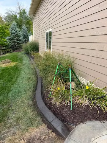 Curved concrete edging with irrigation setup in Princeton, MN