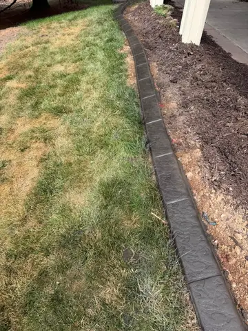 Concrete path leading to patio under deck in Princeton, MN