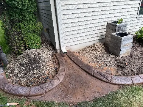 Concrete path leading to patio under deck in Princeton, MN